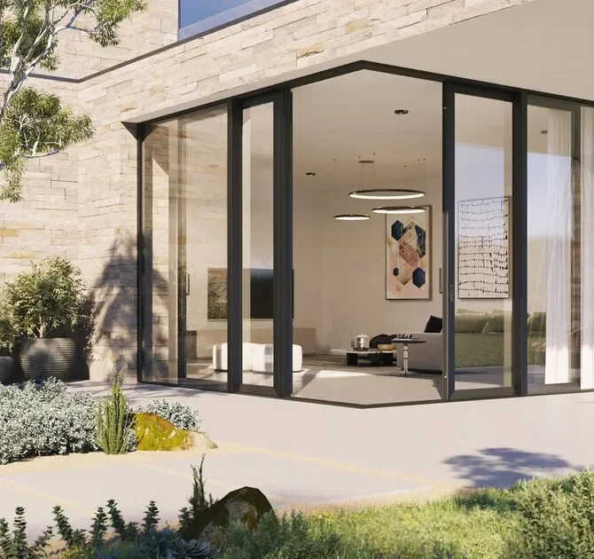 Reynaers open-corner sliding glass system on a modern façade