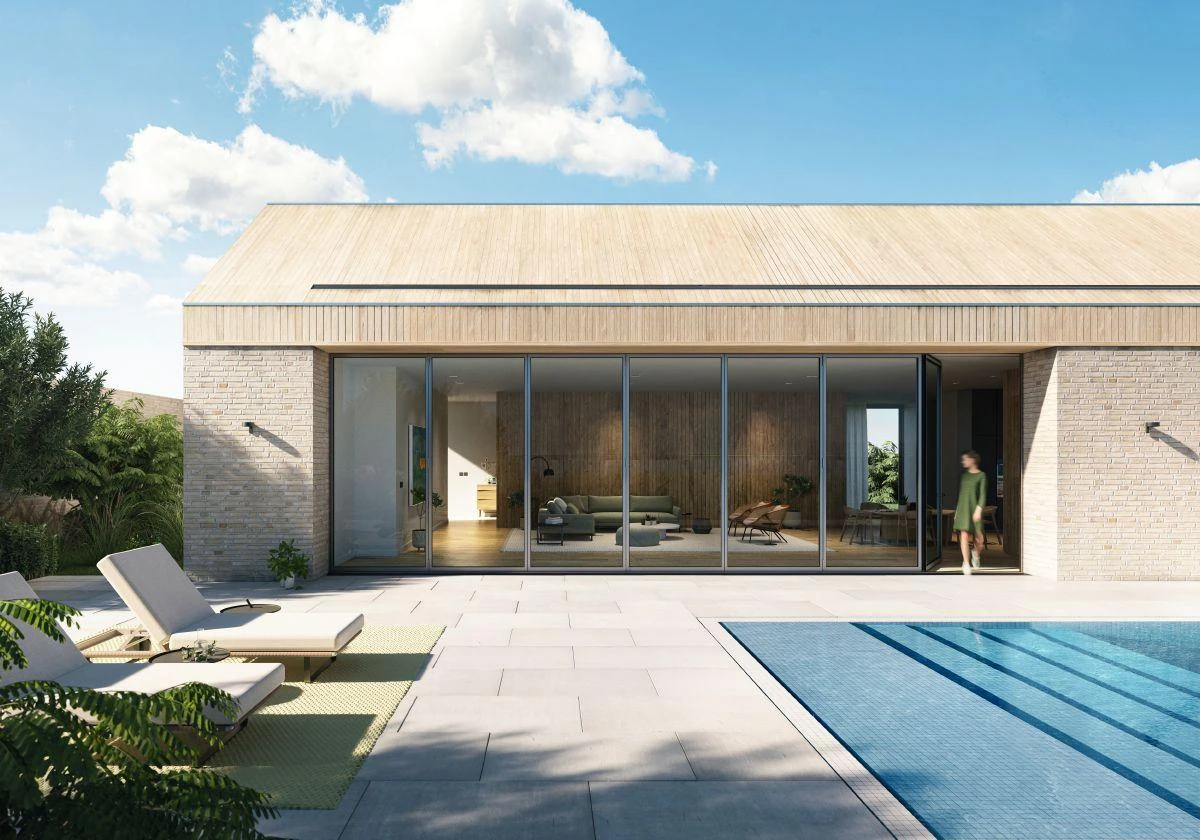 Wide Schüco bifold glass wall facing a pool terrace