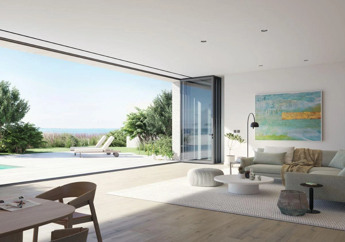 Open Schüco bifold doors connecting a living room to a terrace
