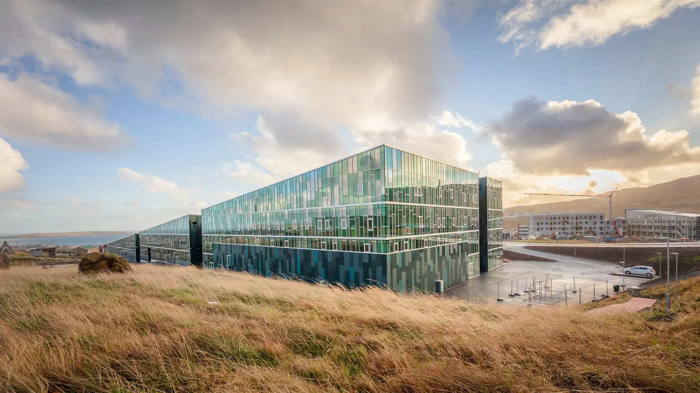 Large glass curtain wall building in the Faroe Islands landscape