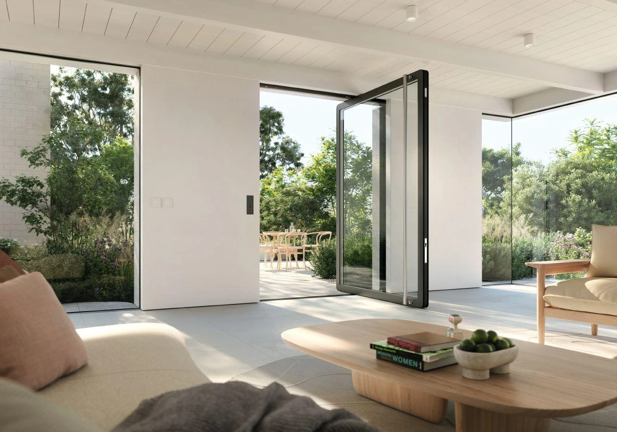 Large Schüco AD AL 75 aluminum pivot door open in a modern luxury home