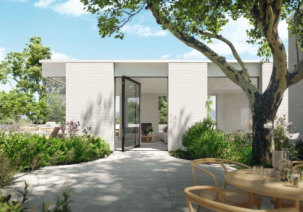 Open full-height glass aluminum pivot door facing a landscaped courtyard