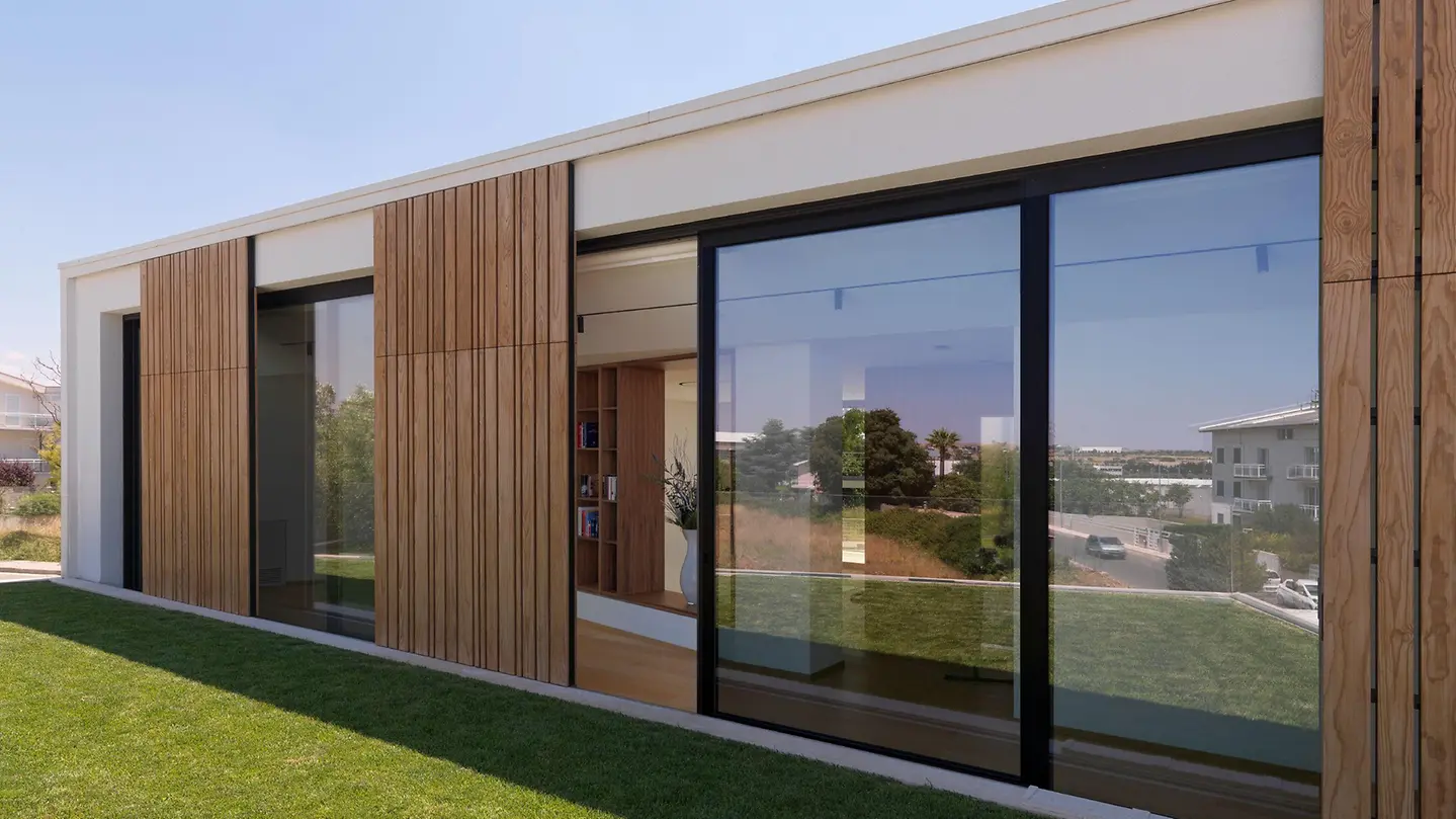 Large Schüco sliding glass doors integrated between timber façade panels